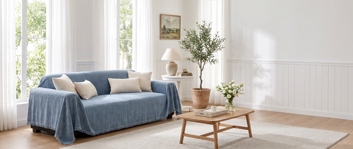 Blue chenille sofa cover in a bright, styled living room